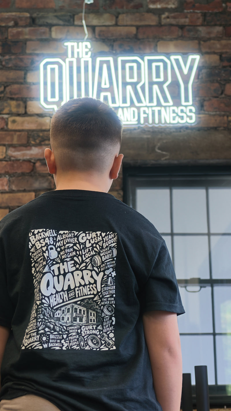 Quarry-branded T-shirt beneath the illuminated Quarry Health and Fitness sign.
